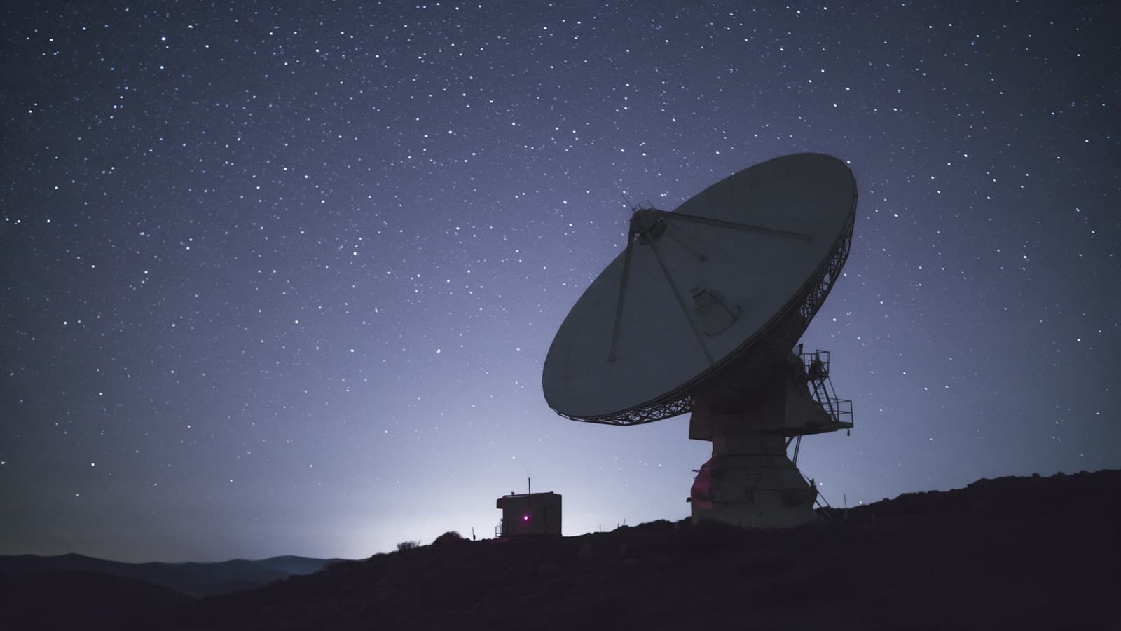 AI-generated illustration: A satellite ground station dish under a night sky